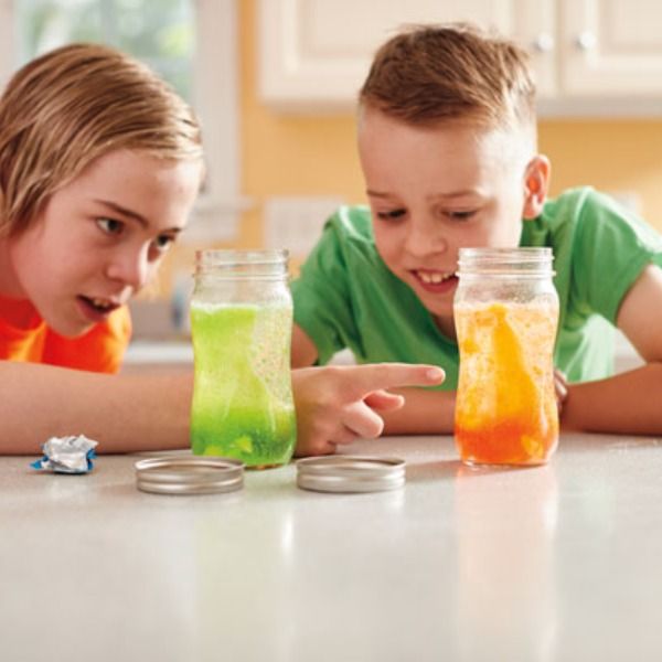 two kids doing kitchen science experiments 