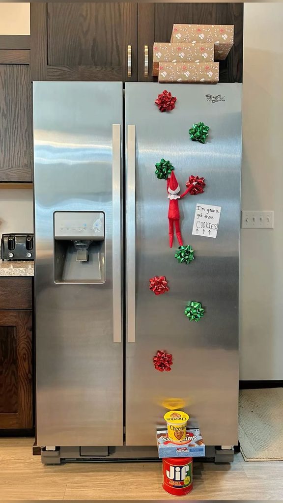 elf climbing the fridge
