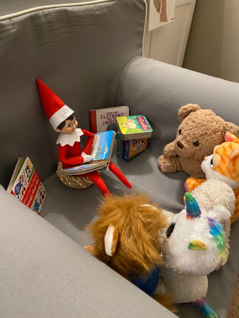 elf reading a story to the stuffed animals as one of creative Elf on the Shelf ideas