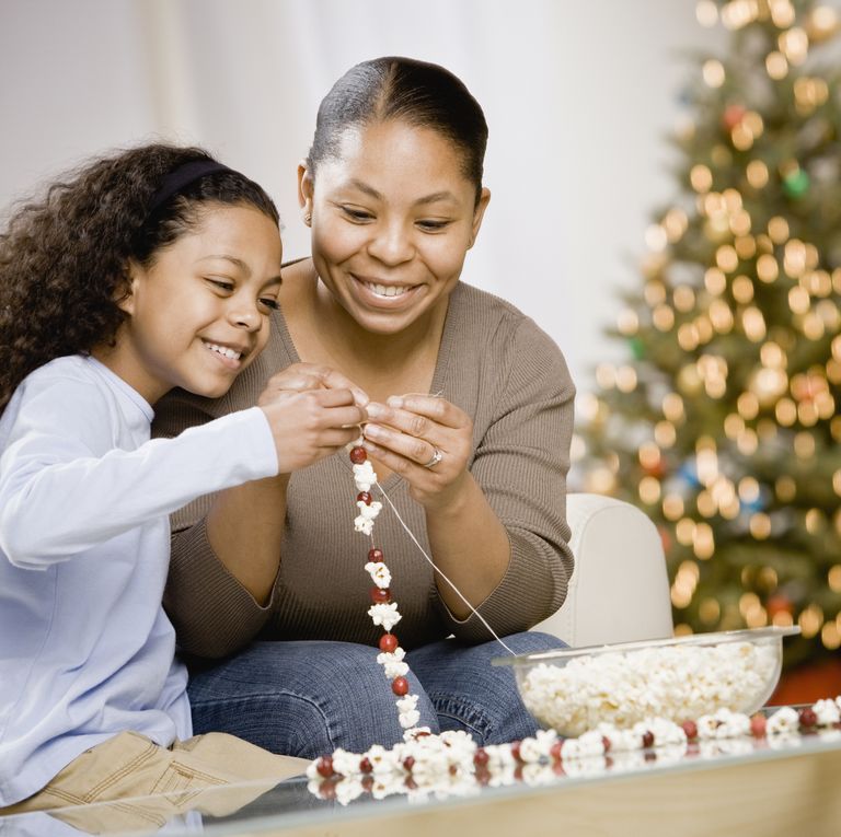 mom and kid making popcorn garlands