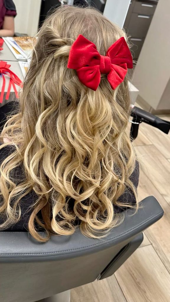 kid with princess half up with a sparkly clip