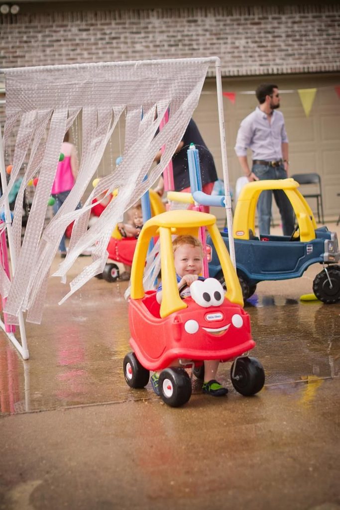 a kid in a toy car wash as backyard activities for kids