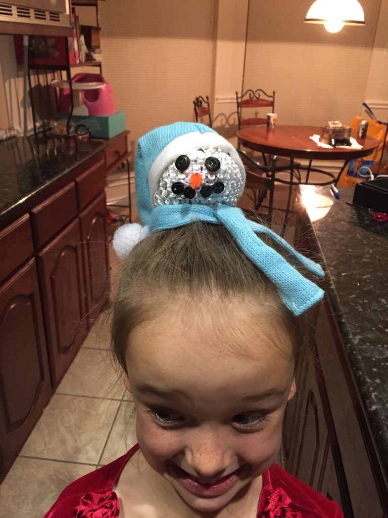 kid with snowman top knots
