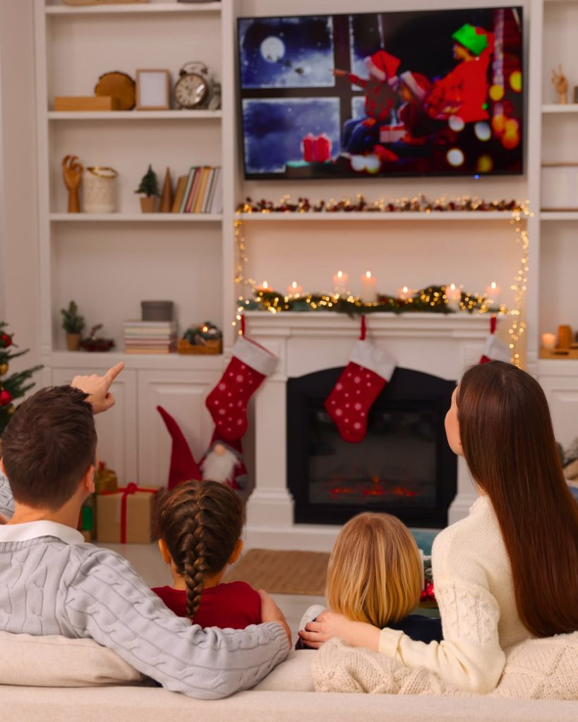 family watching christmas movie as Christmas activities that create magical family memories