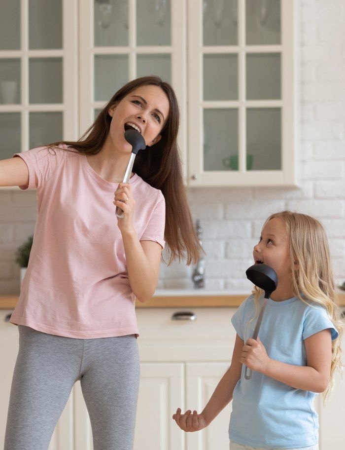 mom and kid singing as part of how to create a home environment where kids thrive