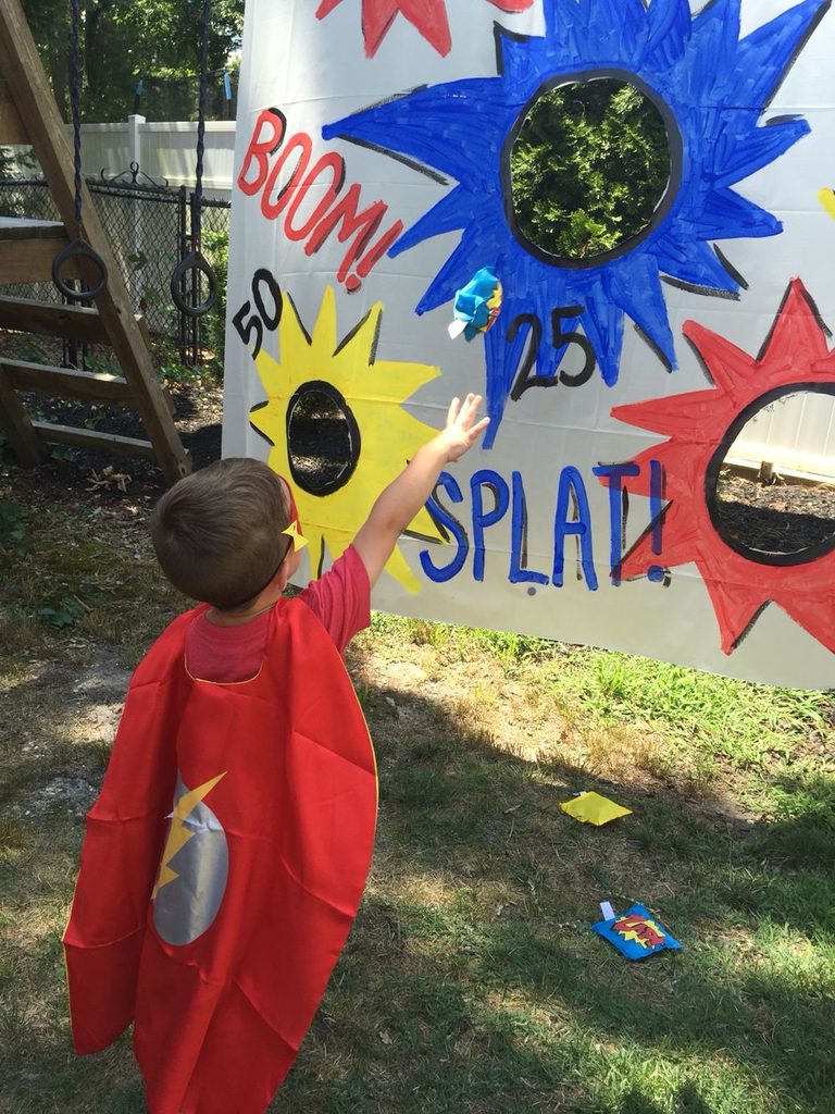 a superhero kid performing magic